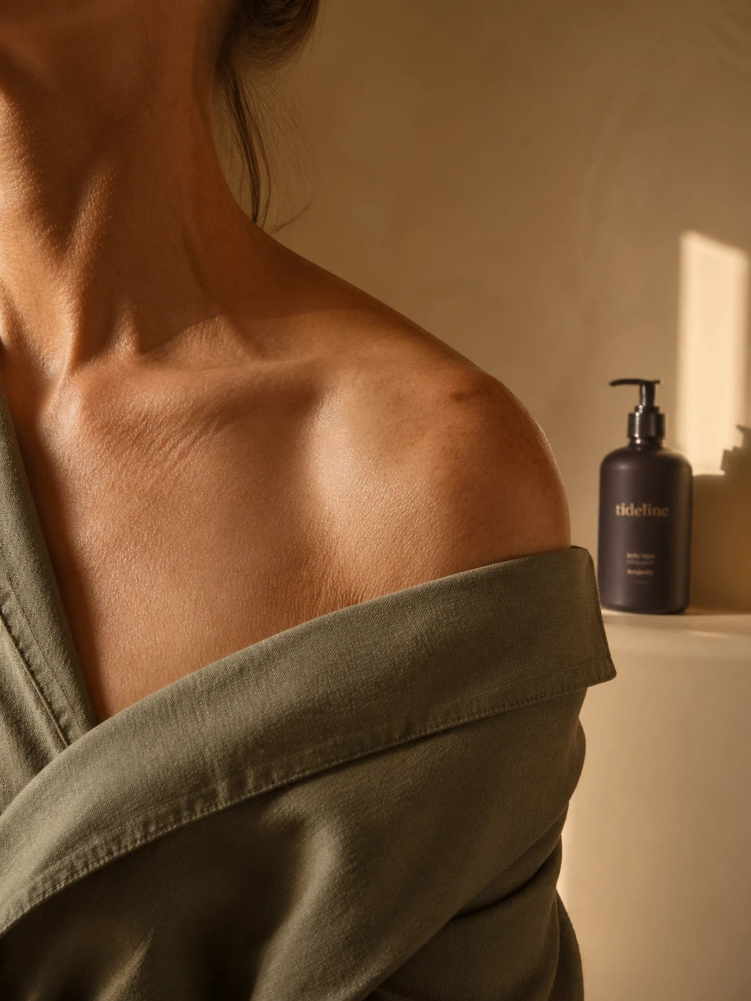 Shoulder fragment with Daily Wash bottle softly behind