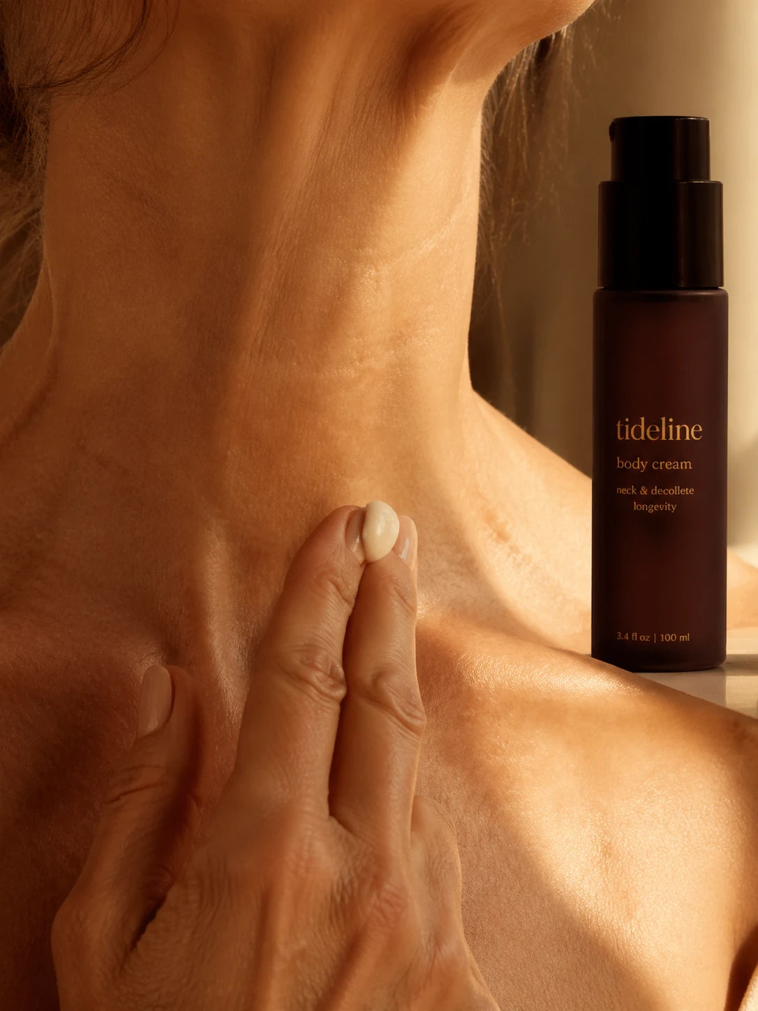 Cream applied upward on the décolleté and neck, body fragment