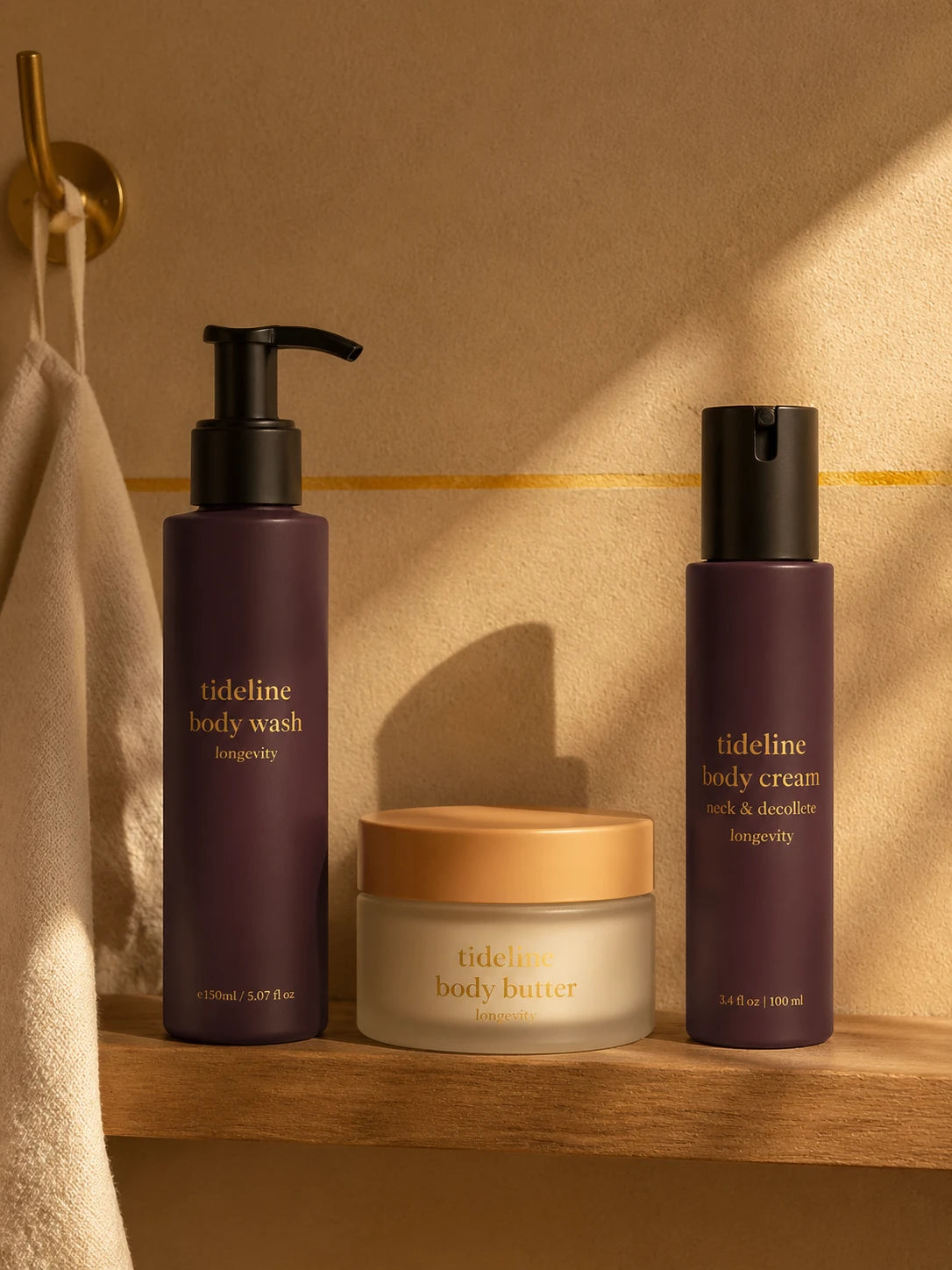 The trio arranged on a narrow oak bathroom shelf with a brass hook and folded linen