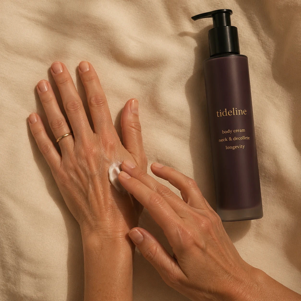 Hand applying daily cream to the back of the other hand